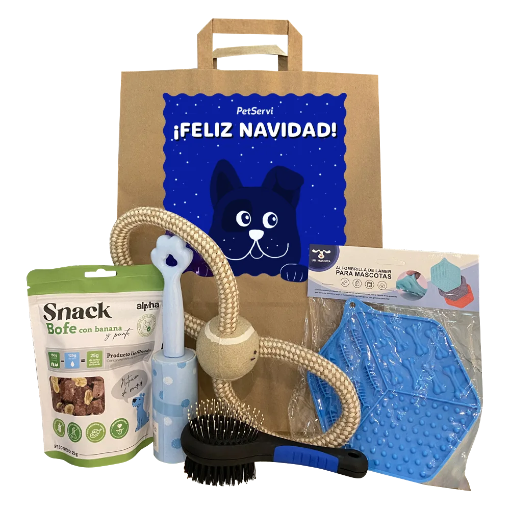 Bolsa de papel kraft con un diseño de perro color azul que dice "Feliz Navidad" y tiene en frente los siguientes productos: un snack para perros, un cepillo negro, una cuerda con forma de 8 y pelota, un roller para quitar pelusa y un plato de goma.