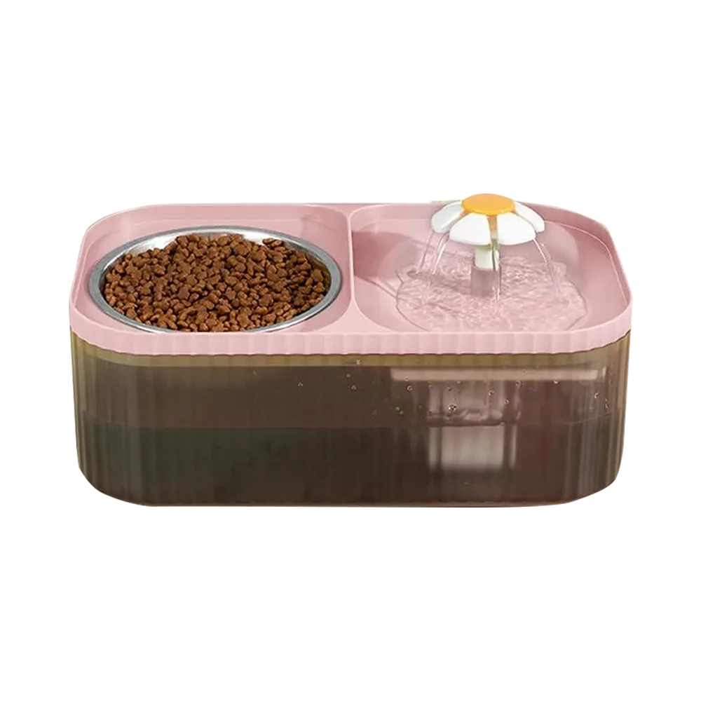 Fuente Automática para mascotas 2 en 1, en un lado tiene una flor por donde sale el agua y circula y en el otro lado tiene un plato de acero inoxidable donde se puede poner croquetas, la base es de color rosado y el cuerpo de un color gris trasnparente.